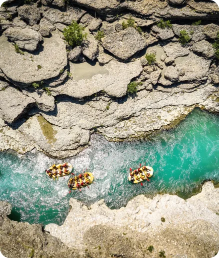 Aerial view of rafts running a river canyon